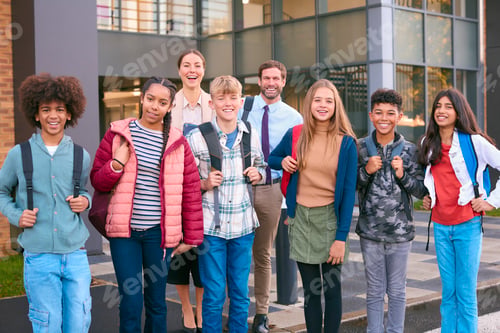 Preview: Portrait Of Class Of Secondary Or High School Pupils Standing Outside School Building With Teachers