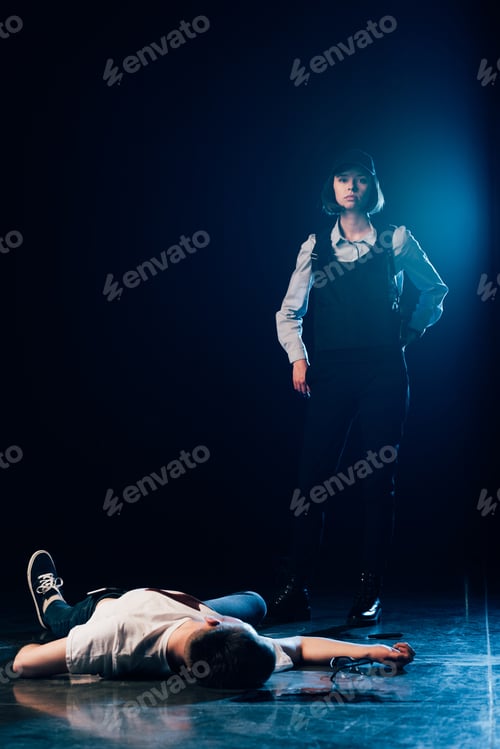 Preview: investigator in uniform standing near corpse at crime scene