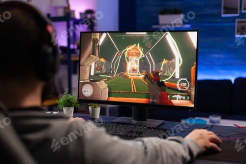 Preview: Man playing video games on computer with mousepad