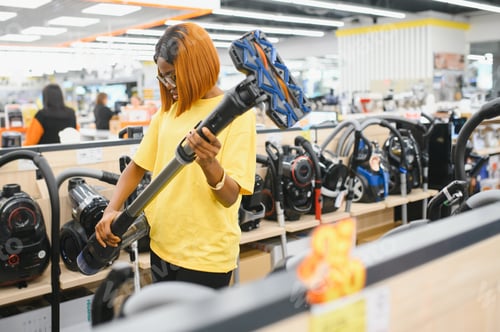 Preview: African american Woman buying vacuum cleaner at store.