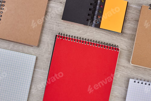 Preview: Colorful notebooks on wooden background.