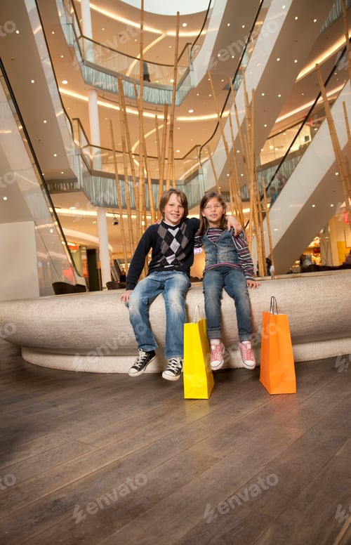 Preview: Brother and sister sitting on a fountain