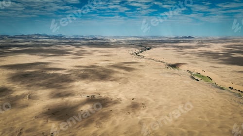 Preview: Aerial view of the vast wild landscape of Angola showcasing arid terrain and distant mountains
