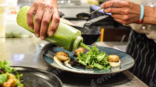 Preview: Mature adult adding a flavorful pesto sauce to a plate of fresh, colorful salad