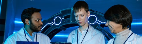 Preview: banner, Exploring Tomorrow, Two scientists and an intern collaborate at a futuristic research center