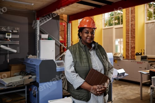 Preview: Black Woman Wearing Hardhat at Factory