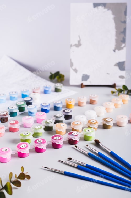 Preview: Painting by numbers kit, paints, brushes and paper on table vertical view