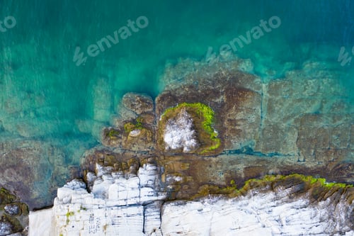 Preview: Aerial drone view of a remote rocky island in open sea.