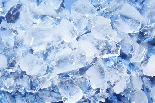 Preview: Pieces of crushed ice on light blue background, above view