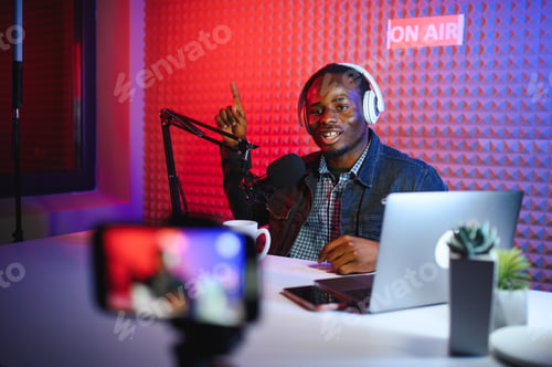 Preview: Handsome Young African American Man Talking Into Microphone While Recording Radio Show