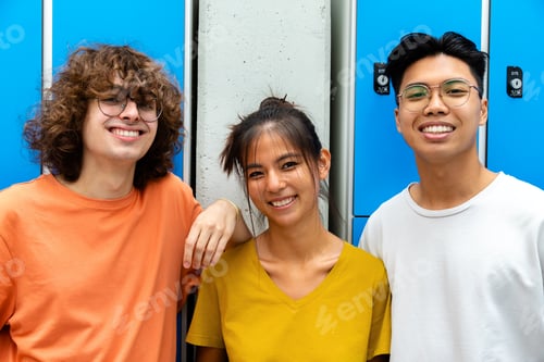 Preview: Happy and smiling multiracial group of teen high school students looking at camera.