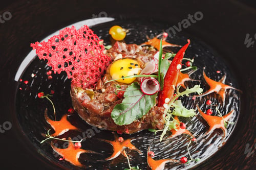 Preview: Modern restaurant dish. Veal tartare with quail egg closeup