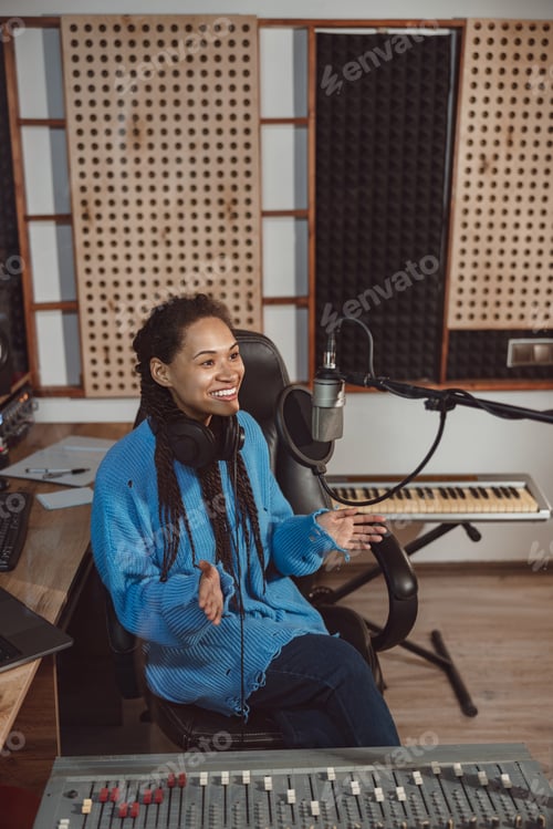 Preview: Presenter talks into microphone while broadcasting interesting program in recording studio