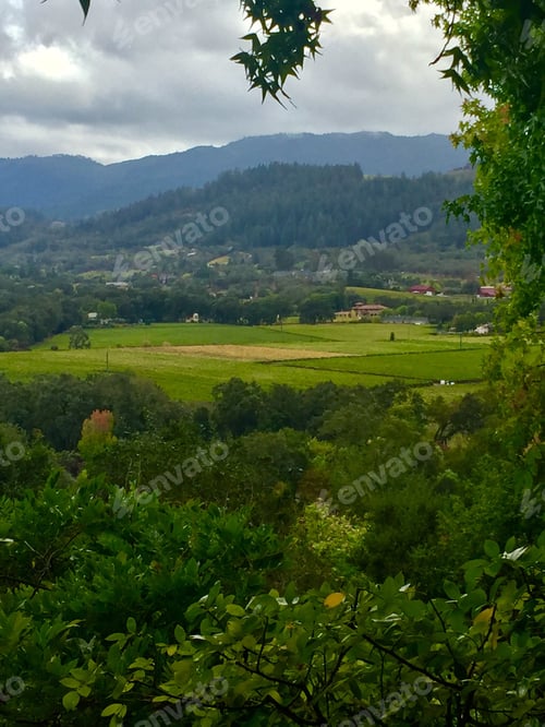 Preview: Lush Green Valley with Distant Mountains