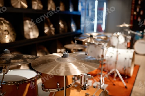 Preview: Selective view on drum set and several golden cymbal plates in music shop