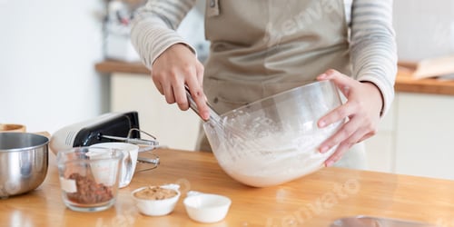 Preview: Close-up of mixing cake batter in modern kitchen setting
