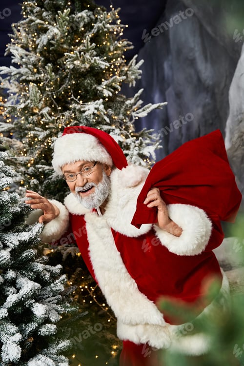 Preview: Santa Claus joyfully prepares for gift delivery in a snowy forest during the holiday season