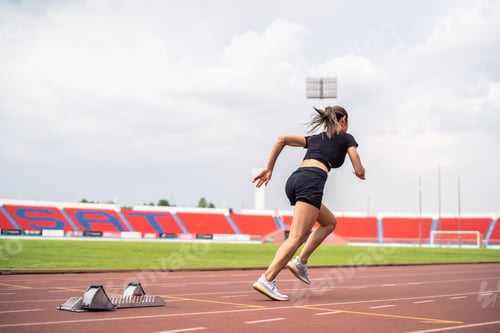 Preview: Asian young sportswoman sprint on a running track outdoors on stadium.