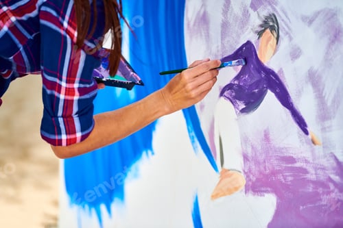 Preview: Female artist working on abstract acrylic painting, hand holding paint brush, large canvas outdoor