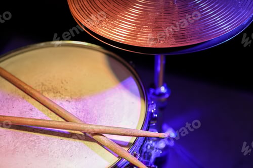 Preview: Drum sticks on a snare drum close up top view.