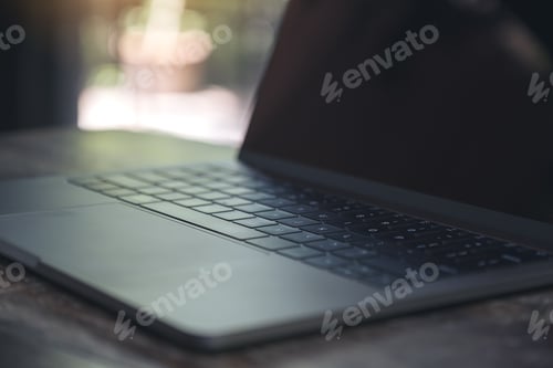Preview: Closeup image of computer laptop on wooden table in cafe
