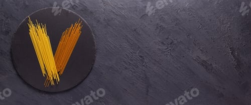 Preview: Pasta spaghetti food on table background. Raw pasta at slate stone