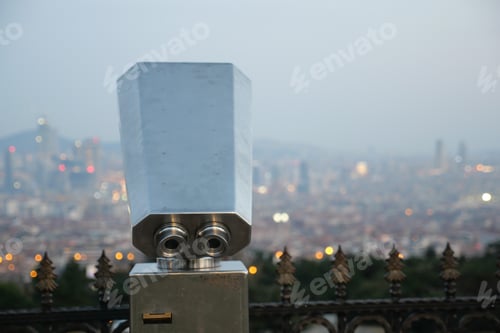 Preview: Coin-operated binoculars looking out over city ,