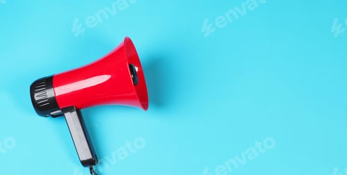 Preview: Red megaphone isolated on blue background.
