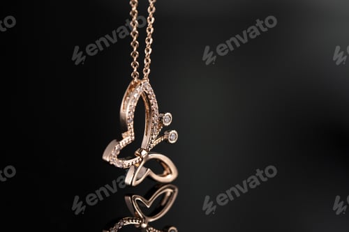 Preview: Selective focus closeup of gold necklace on a black background