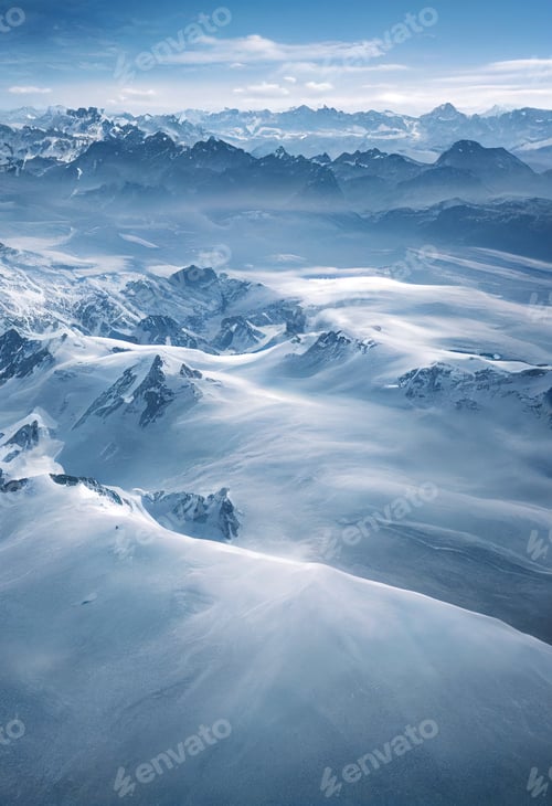 Preview: Aerial drone view of switzerland alps Mountain Range with snow capped peaks in winter.