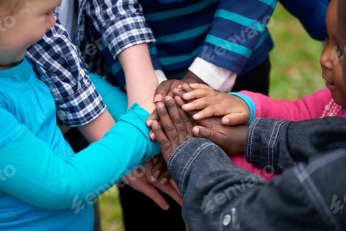 Preview: Friends forever. Shot of a diverse group of children standing with their hands together.