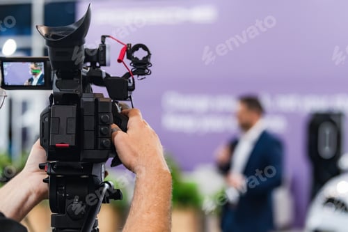 Preview: Professional video camera recording a live media conference event