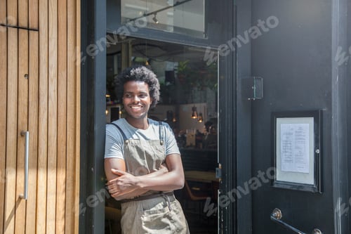 Preview: Portrait of waiter in doorway of city sidewalk cafe