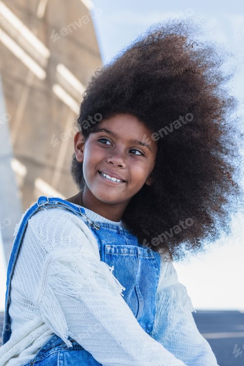 Preview: Smiling black teen girl with curly hair