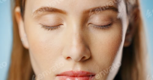Preview: Eyeshadow, beauty and face of woman in studio for makeup, cosmetics or glamour on blue background.