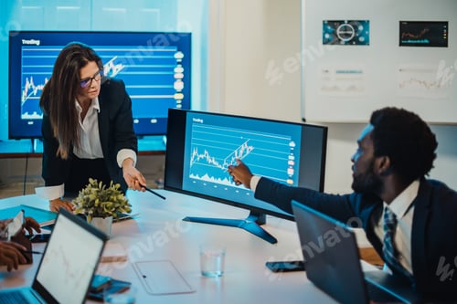 Preview: Multiracial coworkers discussing data on computer
