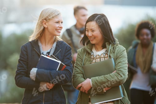 Preview: College life. Shot of a college students between classes on the campus grounds.