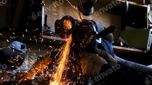 Preview: Close-up of worker cutting metal with grinder. Frame. Sparks while grinding iron. Circular cutting
