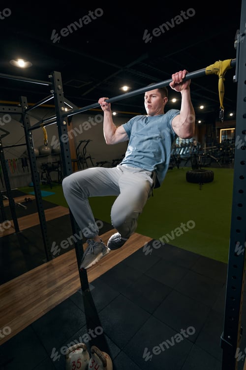 Preview: Gymnast pulling himself up on chin-up bar