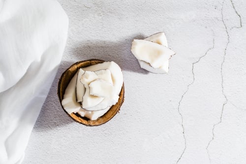 Preview: Pieces of ripe coconut on the table. Natural source of antioxidants. Top view. Close-up