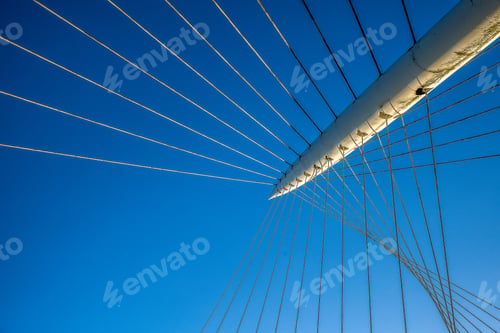 Preview: Low angle shot of a pole with strings attached with a blue sky in the b background