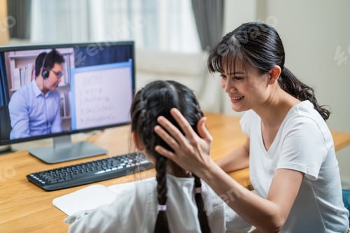 Preview: Asian little girl learning online class from school teacher by digital internet due to covid.