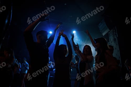 Preview: Energetic crowd. Group of people that enjoying dancing in the nightclub with beautiful lightings