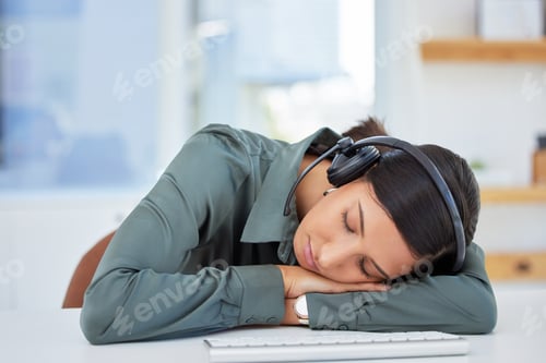 Preview: Just a little rest for my eyes. Shot of an exhausted businesswoman taking a nap at her desk.