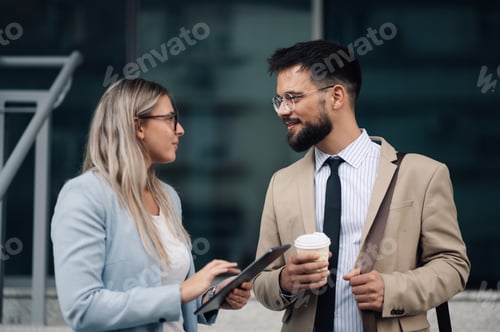 Preview: Businesspeople having conversation about tablet content during coffee break