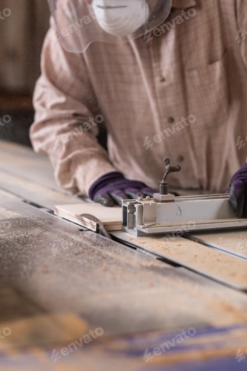 Preview: Manual worker using circular saw machine in carpentry workshop