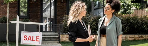 Preview: smiling african american woman talking to blonde property realtor near cottage for sale, banner