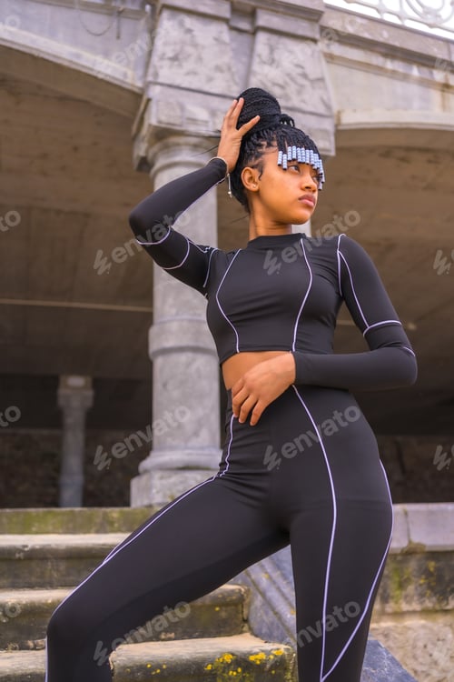Preview: Black ethnic girl with braids with with black full body suit.