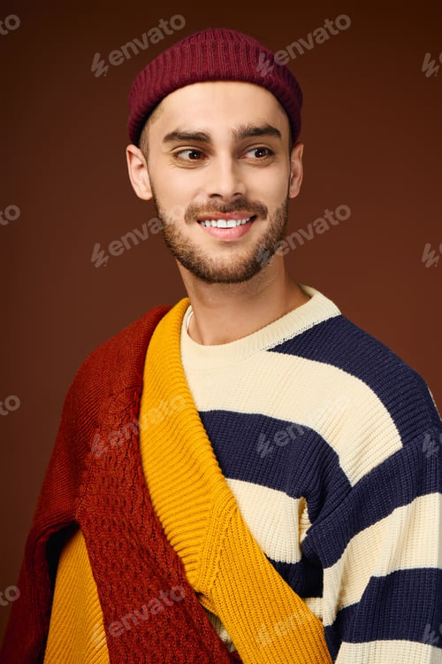 Preview: Young man shows off his style with a trendy beanie and colorful sweater