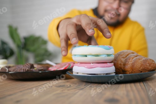 Preview: young man eating donut , selective focus